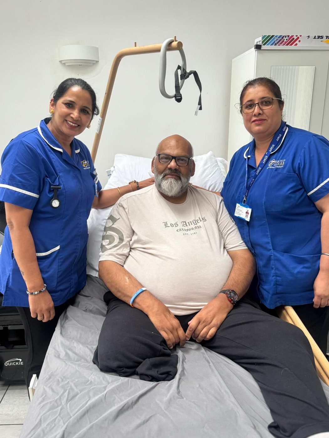 A Trust In Care service user at home with carers Kulwinder and Manjeet