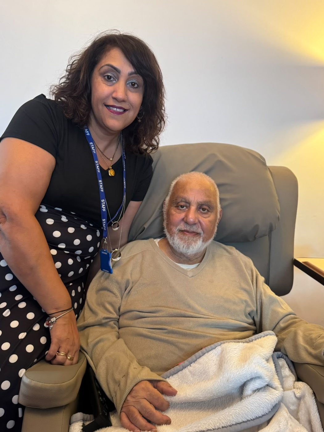 A Trust In Care service user at home with a member of the office team